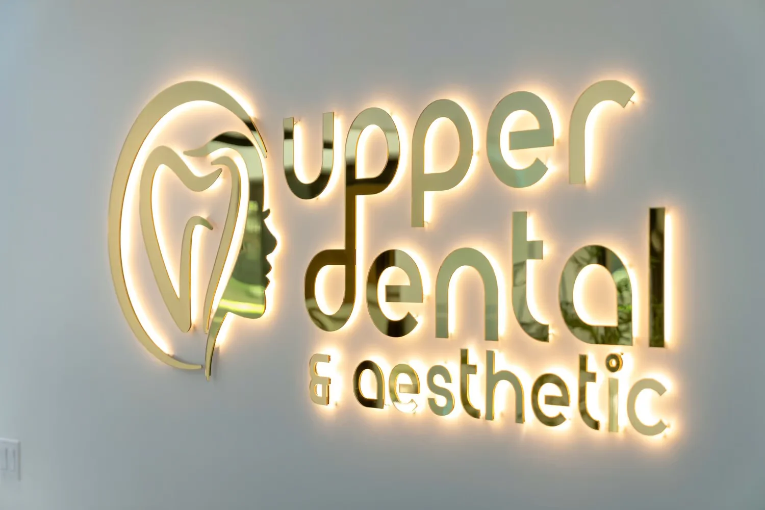 Upper Dental gold logo wall
